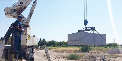 Crane lifting concrete block